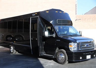 A plain black minibus in a parking lot